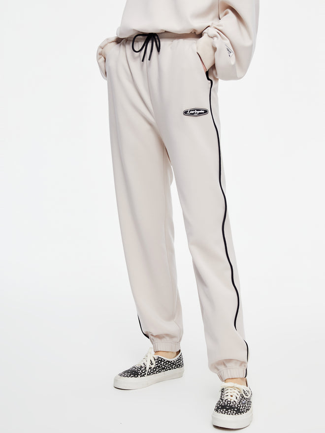 Pantalon à cordon passepoilé beige et blanc